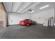 This garage features high ceilings and painted walls and floors with a car parked inside at 732 Rosewater Dr, Henderson, NV 89011