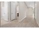 Hallway with tile flooring and multiple doors including entry to a laundry room and the main bathroom at 732 Rosewater Dr, Henderson, NV 89011