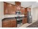 Well-lit kitchen with stainless steel appliances, granite countertops, and wood cabinets at 732 Rosewater Dr, Henderson, NV 89011