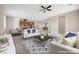 Open-concept living room with modern furniture, ceiling fan, and view of the dining area and kitchen at 732 Rosewater Dr, Henderson, NV 89011