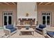 Cozy outdoor seating area with a brick fireplace and elegant decorative lanterns at 732 Rosewater Dr, Henderson, NV 89011