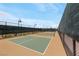 Exterior view of pickleball courts featuring new green playing surfaces and dark fencing at 732 Rosewater Dr, Henderson, NV 89011