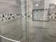 Close-up of bathroom with an updated shower, decorative tile, and a built-in niche at 8455 W Sahara Ave # 258, Las Vegas, NV 89117