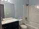 Bathroom features vanity with dark cabinets, white countertop, and shower-tub combo at 8455 W Sahara Ave # 258, Las Vegas, NV 89117