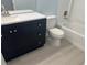 Bathroom features a vanity with a dark cabinet and shower-tub combo at 8455 W Sahara Ave # 258, Las Vegas, NV 89117