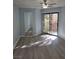 Bright bedroom featuring wood floors, a ceiling fan, and a sliding glass door to the balcony at 8455 W Sahara Ave # 258, Las Vegas, NV 89117