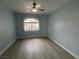 Simple bedroom with wood-style flooring and a large window at 8455 W Sahara Ave # 258, Las Vegas, NV 89117
