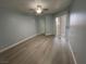 Bedroom with laminate flooring, ceiling fan, and a sliding glass door to a balcony at 8455 W Sahara Ave # 258, Las Vegas, NV 89117