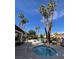 Community hot tub area offering a relaxing outdoor space surrounded by palm trees at 8455 W Sahara Ave # 258, Las Vegas, NV 89117
