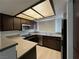 Compact kitchen with stainless steel appliances, wood cabinets, and laminate countertops at 8455 W Sahara Ave # 258, Las Vegas, NV 89117