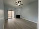 Living room featuring laminate flooring, ceiling fan, and sliding glass doors to a balcony at 8455 W Sahara Ave # 258, Las Vegas, NV 89117