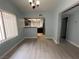 Bright open-concept living and dining area with laminate flooring and neutral wall colors at 8455 W Sahara Ave # 258, Las Vegas, NV 89117