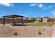 Well-maintained community park featuring a shaded picnic area and lush green space for residents' enjoyment at 9070 Rivington Ave, Las Vegas, NV 89148