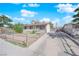Single story home with a large driveway and fenced yard on a clear day at 916 Putnam Ave, North Las Vegas, NV 89030