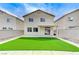 The spacious backyard features artificial turf, a patio, and a privacy wall, creating a great outdoor area at 9264 Ansley Ct, Las Vegas, NV 89148