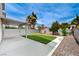 A backyard features artificial turf, rock landscaping, and a covered patio area, perfect for outdoor entertaining at 9264 Ansley Ct, Las Vegas, NV 89148