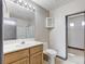 Bathroom featuring a vanity, walk-in shower, toilet, and view into a walk-in closet at 9264 Ansley Ct, Las Vegas, NV 89148