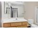 Bathroom featuring a single sink vanity and shower over tub with glass doors at 9264 Ansley Ct, Las Vegas, NV 89148