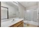 Bathroom featuring a single sink vanity and shower over tub with glass doors at 9264 Ansley Ct, Las Vegas, NV 89148