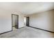 Spacious bedroom featuring neutral walls, plush carpeting, and two access doors at 9264 Ansley Ct, Las Vegas, NV 89148