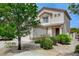 Exterior view of home with neutral stucco, brown trim and desert landscaping at 9264 Ansley Ct, Las Vegas, NV 89148