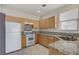Charming kitchen with stone countertops, cabinets, backsplash, and stainless sink at 9264 Ansley Ct, Las Vegas, NV 89148