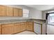 Bright kitchen with stone countertops, stainless sink and dishwasher, and outside patio access at 9264 Ansley Ct, Las Vegas, NV 89148