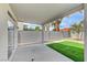 Covered patio offers an outdoor living space, views of the artificial turf lawn, and is perfect for relaxation at 9264 Ansley Ct, Las Vegas, NV 89148