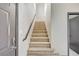 Carpeted staircase features neutral walls, dark trim, and access to second-floor bedrooms at 9264 Ansley Ct, Las Vegas, NV 89148