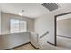 Upstairs hallway with carpet and window with blinds in a neutral-color home at 9264 Ansley Ct, Las Vegas, NV 89148