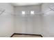 A well-organized walk-in closet featuring wire shelving and two small windows at 9264 Ansley Ct, Las Vegas, NV 89148