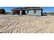 Unfinished single-story home exterior featuring block construction and an expansive lot at 970 Mount Charleston Dr, Pahrump, NV 89048