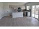 Modern kitchen with white cabinets, an island, and stainless-steel appliances open to living area at 970 Mount Charleston Dr, Pahrump, NV 89048