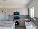 Modern kitchen with white cabinets, an island, and stainless-steel appliances at 970 Mount Charleston Dr, Pahrump, NV 89048