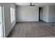Open concept living room with laminate flooring, ceiling fan and bright natural light at 970 Mount Charleston Dr, Pahrump, NV 89048