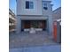 New construction showing the two-story facade and open garage with building supplies at 9989 River Corral St, Las Vegas, NV 89166