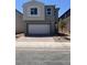 Two-story home with a neutral color scheme, a two-car garage, and low-maintenance landscaping at 9989 River Corral St, Las Vegas, NV 89166