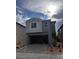 Beautiful two-story home featuring an open garage, neutral colors, and modern design at 9989 River Corral St, Las Vegas, NV 89166