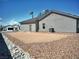 Exterior rear view of home, showing low maintenance gravel landscaping at 1931 Rose Ct, Pahrump, NV 89048