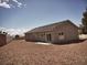Wide backyard with neutral stone landscaping and private block fencing at 1931 Rose Ct, Pahrump, NV 89048