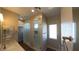 Modern bathroom featuring a glass shower, light countertops, and wood-look tile floors at 1931 Rose Ct, Pahrump, NV 89048