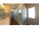 A well-lit bathroom featuring a glass shower, contemporary fixtures, and tile flooring at 1931 Rose Ct, Pahrump, NV 89048