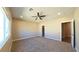 Spacious carpeted bedroom with ceiling fan, closet, and large window at 1931 Rose Ct, Pahrump, NV 89048