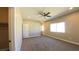 Bright, carpeted bedroom with ceiling fan, closet and a bright window at 1931 Rose Ct, Pahrump, NV 89048