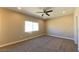 Comfortable bedroom featuring neutral carpet, ceiling fan and natural light at 1931 Rose Ct, Pahrump, NV 89048
