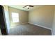 Cozy bedroom with neutral carpet, ceiling fan and a bright window at 1931 Rose Ct, Pahrump, NV 89048