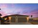Charming single-story home featuring a two-car garage and desert landscaping at 1931 Rose Ct, Pahrump, NV 89048