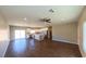 Bright and open living space with hardwood floors, ceiling fan, and stainless steel appliances in the kitchen at 1931 Rose Ct, Pahrump, NV 89048