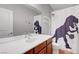 Updated bathroom featuring a single vanity, shower with fun dinosaur shower curtain, and toilet at 2641 Vendange Pl, Henderson, NV 89044
