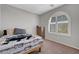Bright bedroom with a full bed, an arch window, and carpet flooring at 2641 Vendange Pl, Henderson, NV 89044